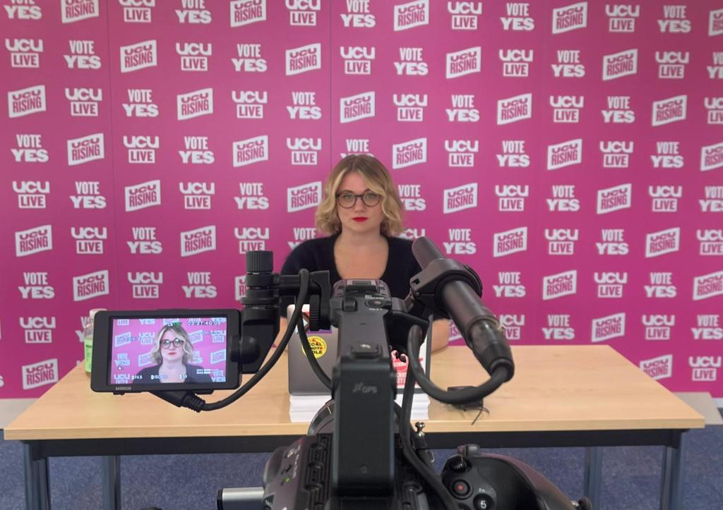 Jo Grady sits in front of a Camera ready to do a livestream for UCU Rising.