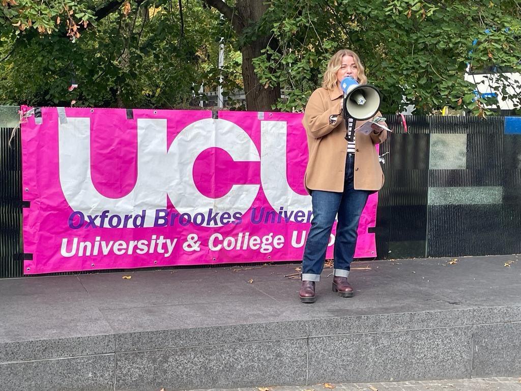 Jo Grady holds megaphone a making a speech in front on an Oxford Brooke UCU banners