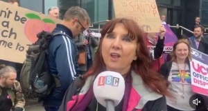 Linda Littler talking into an LBC microphone on a picket line. 